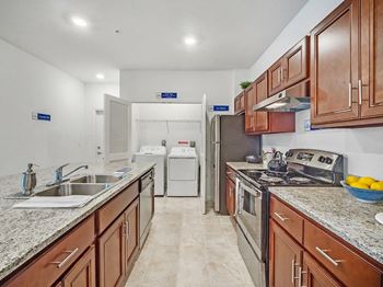 a kitchen with wood cabinets and stainless steel appliances